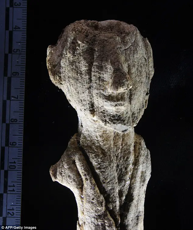 Bearded figure: The archaeologists found an ivory statue of a bearded man (pictured) and the mummy of the tomb's owner, who appeared to have died in his late teenage years