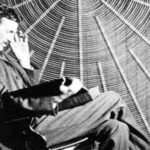 A rare image of Nikola Tesla next to his spiral coil.