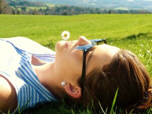 woman laying in the grass field